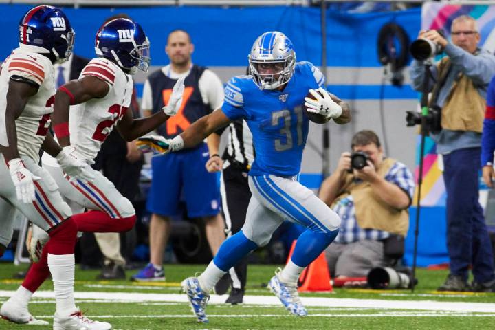 Detroit Lions running back Ty Johnson (31) rushes against the New York Giants during an NFL foo ...