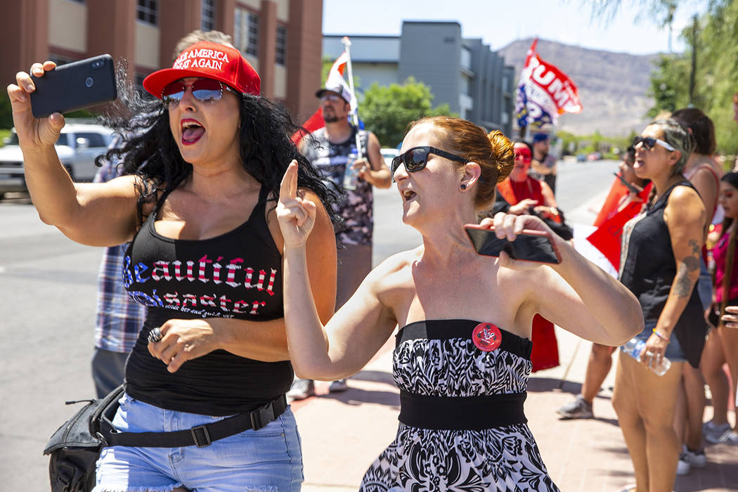 Counter protester Jennifer Harrison, left, with the AZ Patriots group, live-streams as Tamara T ...