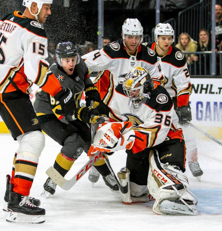 Vegas Golden Knights center Jonathan Marchessault (81) battles to get the puck past Anaheim Duc ...