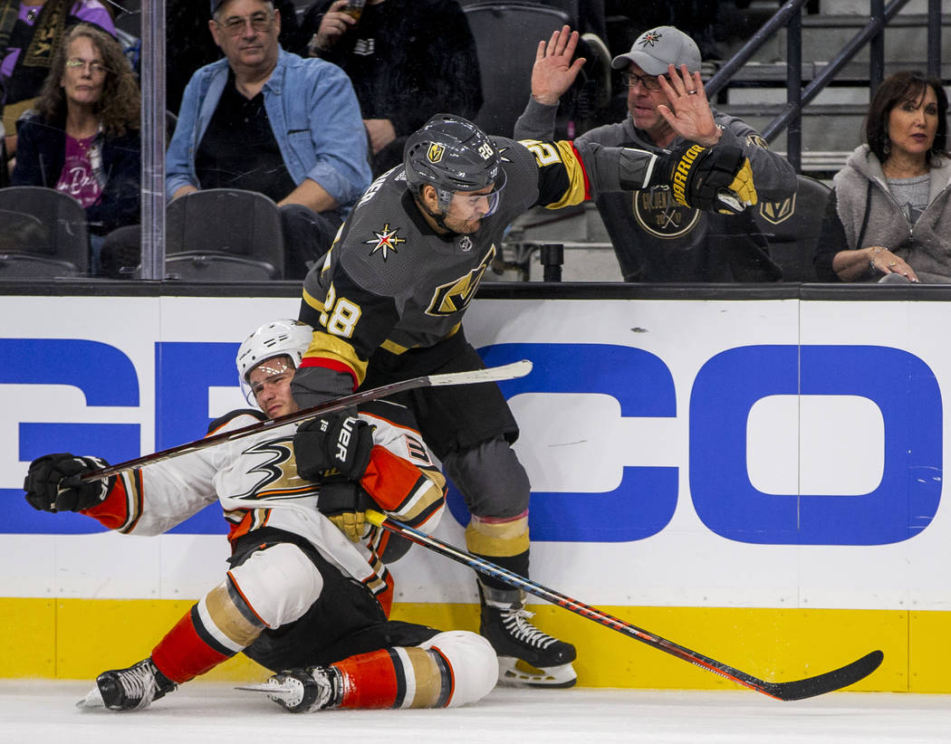 Anaheim Ducks center Sam Steel (34) is taken down by Vegas Golden Knights left wing William Car ...