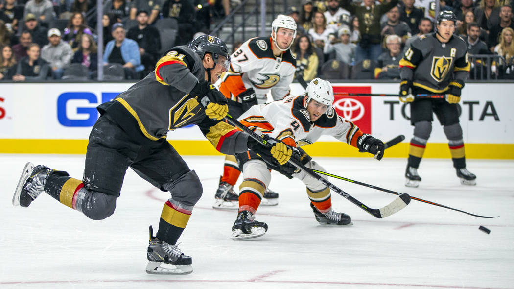 Vegas Golden Knights center Cody Eakin (21) fires a shot at goal past Anaheim Ducks defenseman ...