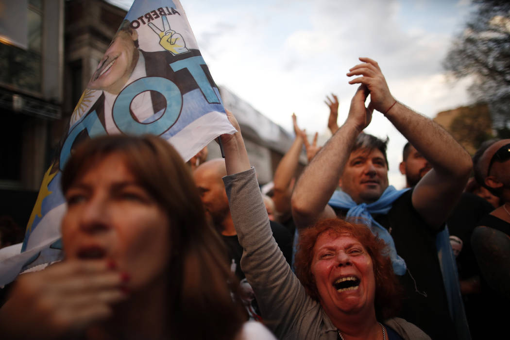 Supporters of center-left Peronist presidential candidate Alberto Fernández and running ma ...
