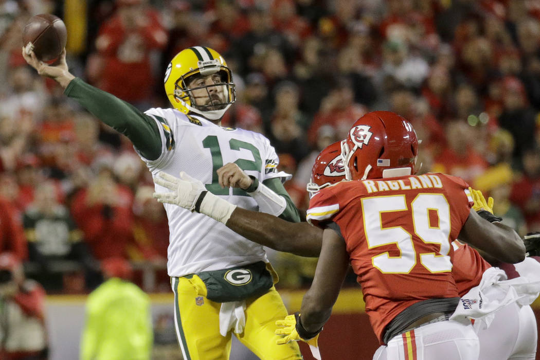 Green Bay Packers quarterback Aaron Rodgers (12) throws a pass under pressure from Kansas City ...
