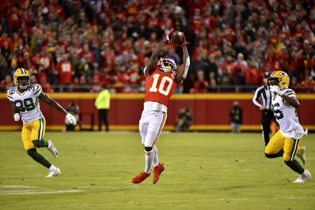 Kansas City Chiefs wide receiver Tyreek Hill (10) makes a catch between Green Bay Packers corne ...