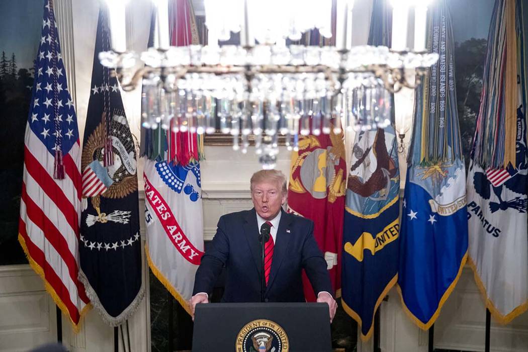 President Donald Trump speaks in the Diplomatic Room of the White House in Washington, Sunday, ...