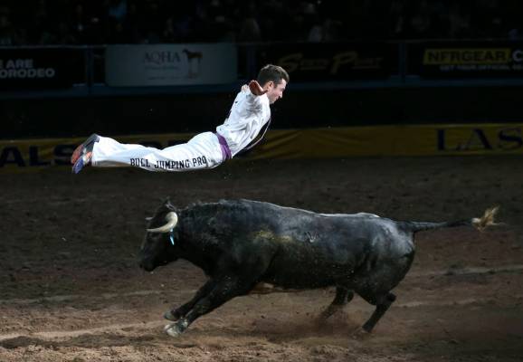 Bull Jumping Pro Emmanuel Lataste leaps over a running bull during a performance on the third g ...