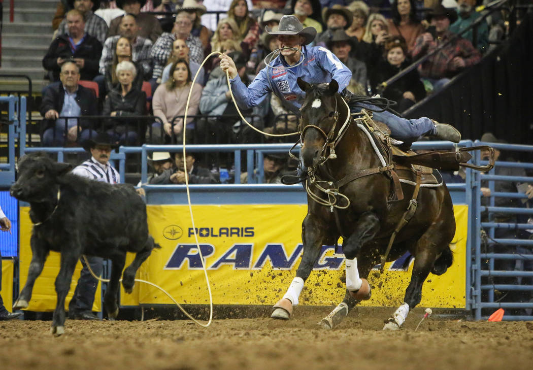 Tuf Cooper of Decatur, Texas (1) competes in tie-down roping during the tenth go-round of the N ...