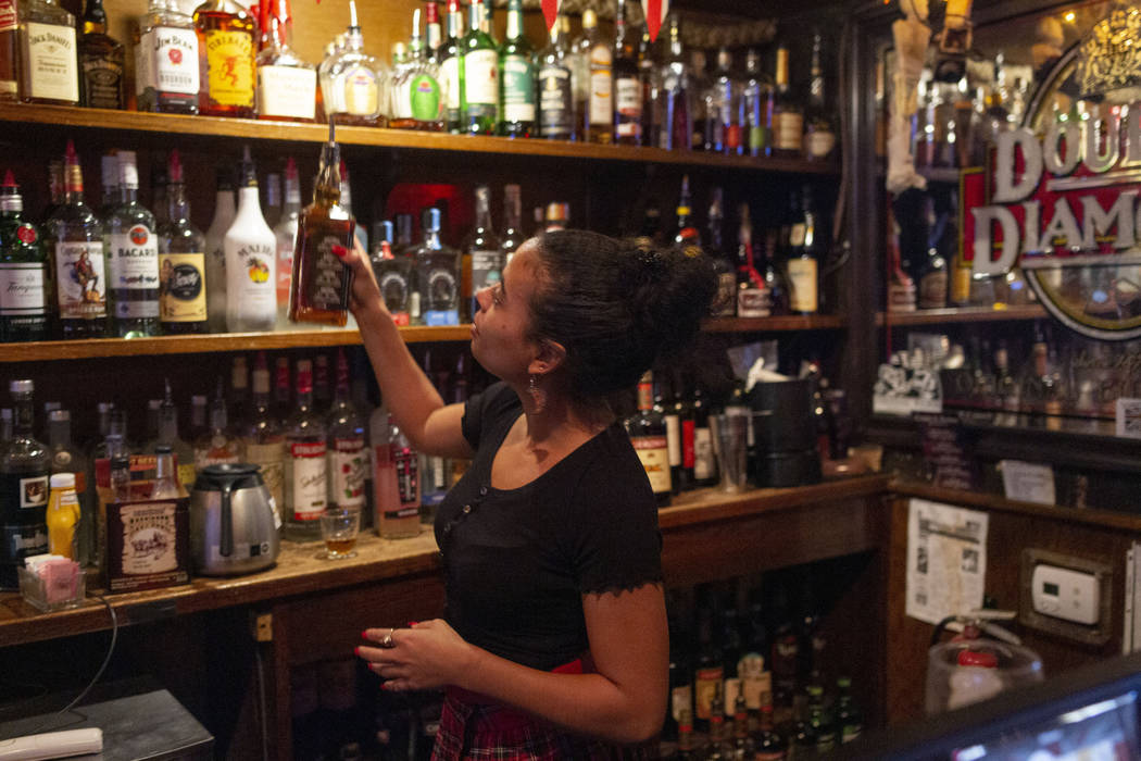 Bartender Lindsey Cruz pours a drink while sharing her experience with the supernatural earlier ...