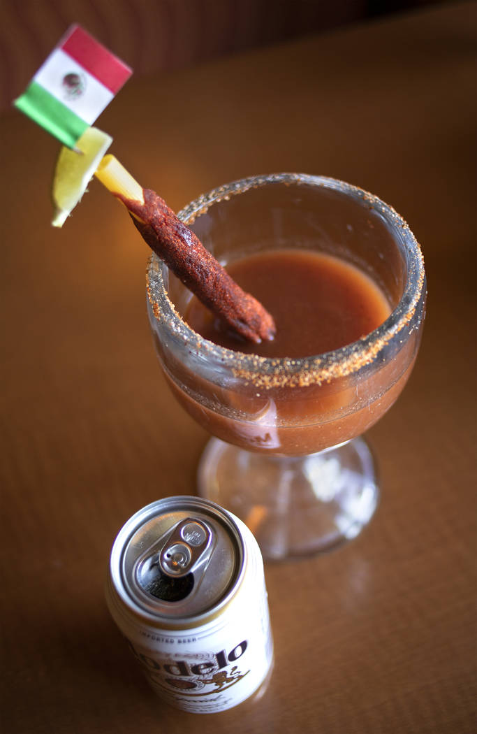 Rise & Shine's homemade Michelada is adorned with a Mexican flag, Modelo beer and rimmed with h ...