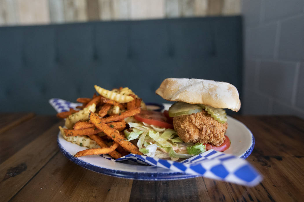 Mama Bird's fried chicken sandwich sits high on a potato roll at the restaurant on Friday, Oct. ...