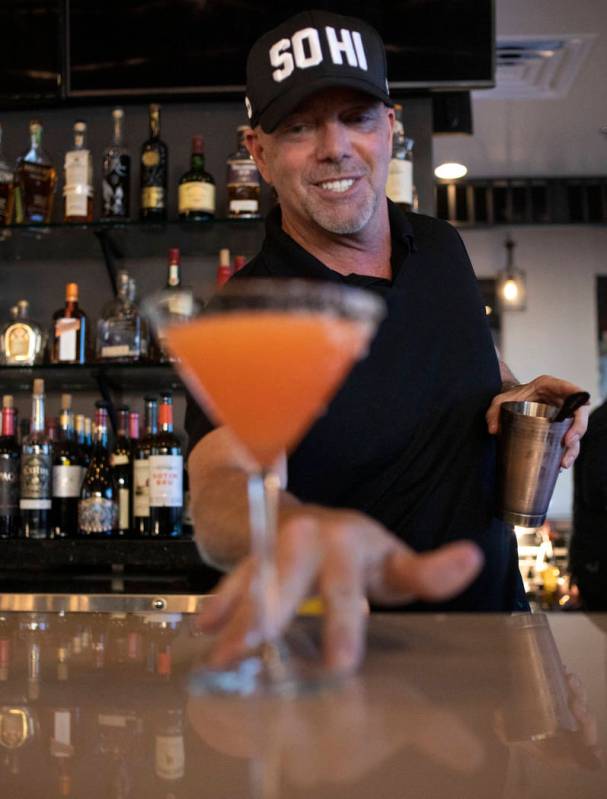 Bartender lead David Cooper pours an aperitif with fresh grapefruit juice and bitters at Spaghe ...