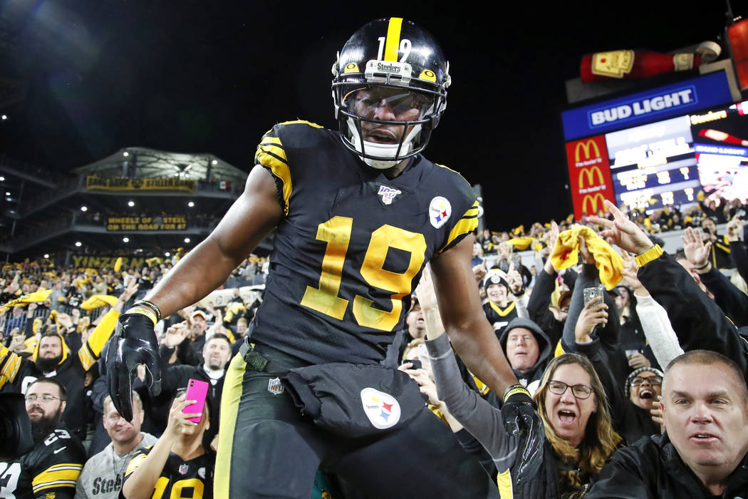 Pittsburgh Steelers wide receiver JuJu Smith-Schuster (19) climbs down from the stands after ce ...