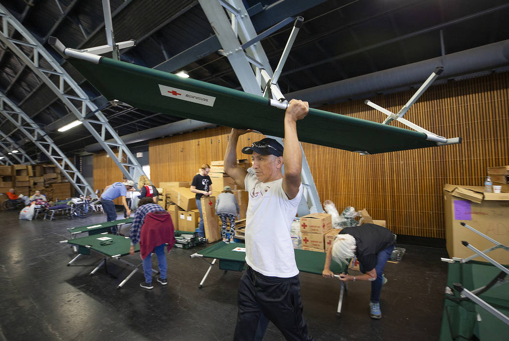 In this Sunday, Oct. 27, 2019, photo, volunteer Alejandro Pablo carries a newly built cot to an ...