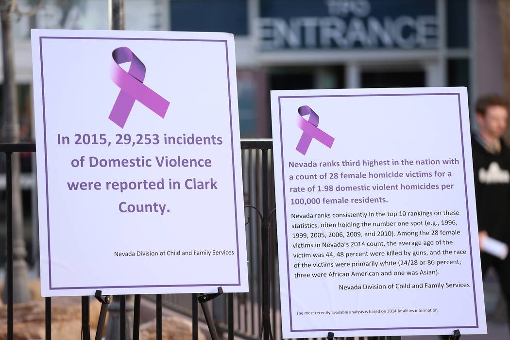 Signs on display during a press conference regarding the One-Stop Protective Order Center at th ...