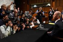 Boeing Company President and Chief Executive Officer Dennis Muilenburg, right, is surrounded by ...