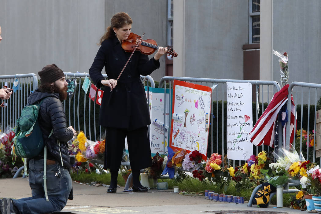 Monique Mead plays her violin on the sidewalk outside the Tree of Life synagogue in Pittsburgh ...