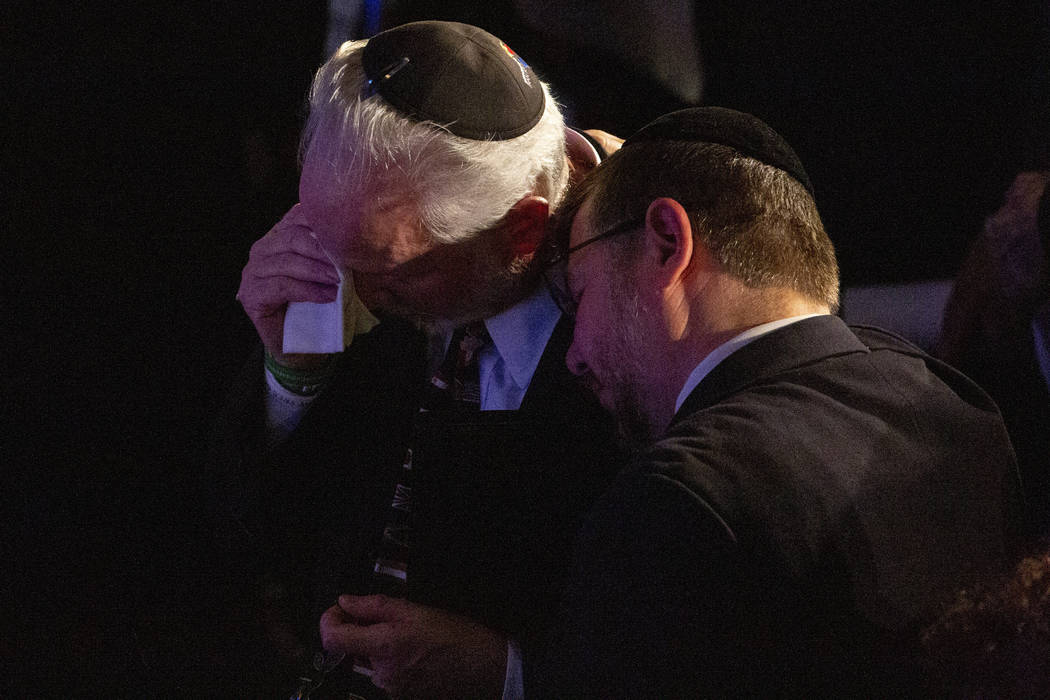 Rabbi Jeffrey Myers, center, of the Tree of Life/Or L'Simcha Congregation, is comforted after s ...