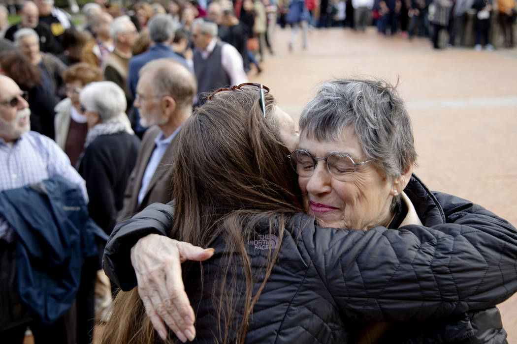 Laura Fehl, left, hugs Esther Nathanson as they arrive for the one-year commemoration of the Tr ...