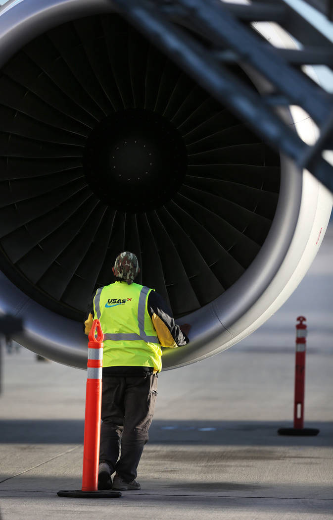 An airline worker inspects the engine of Level's first non-stop transatlantic service between P ...