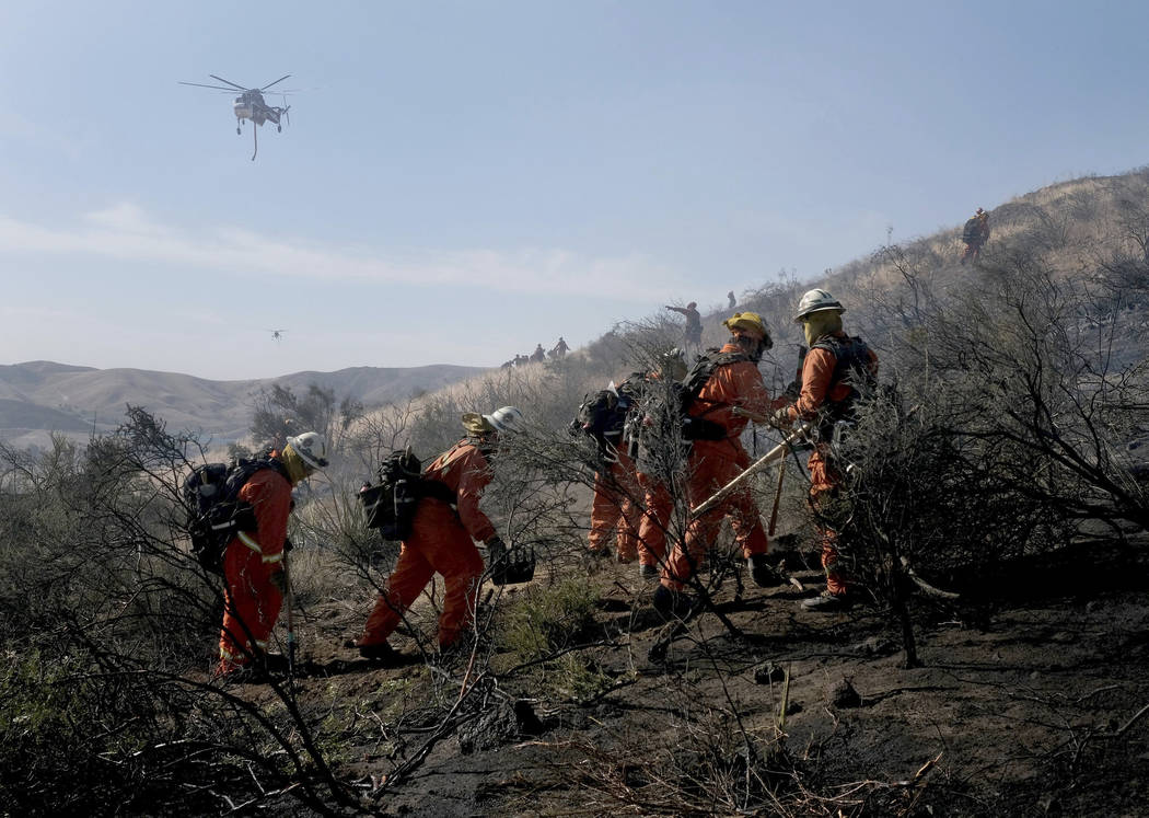 Firefighters battle the Easy Fire in Simi Valley, Calif., near the Ronald Reagan Library on Wed ...
