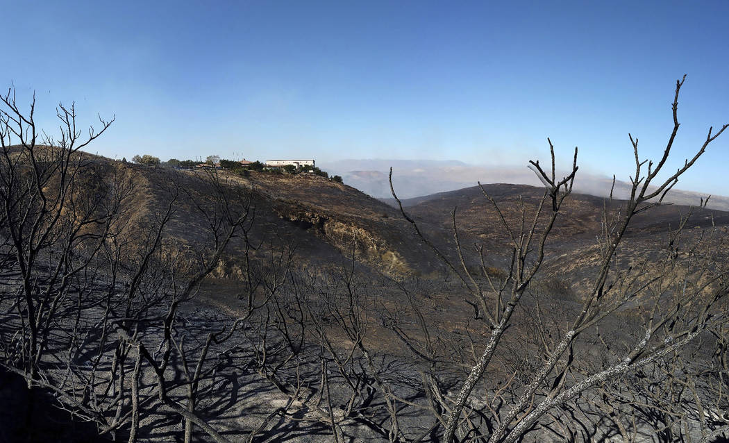 Burned hillsides surround the Ronald Reagan Presidential Library on Wednesday, Oct. 30, 2019, i ...
