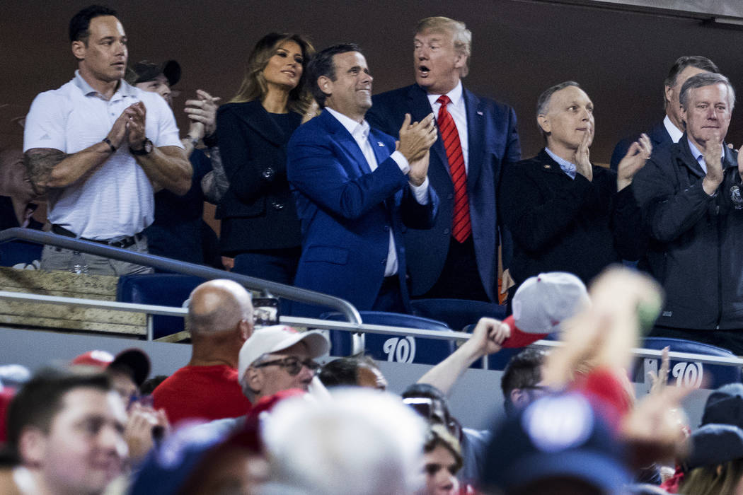 President Donald Trump, third from right, accompanied by first lady Melania Trump, second from ...