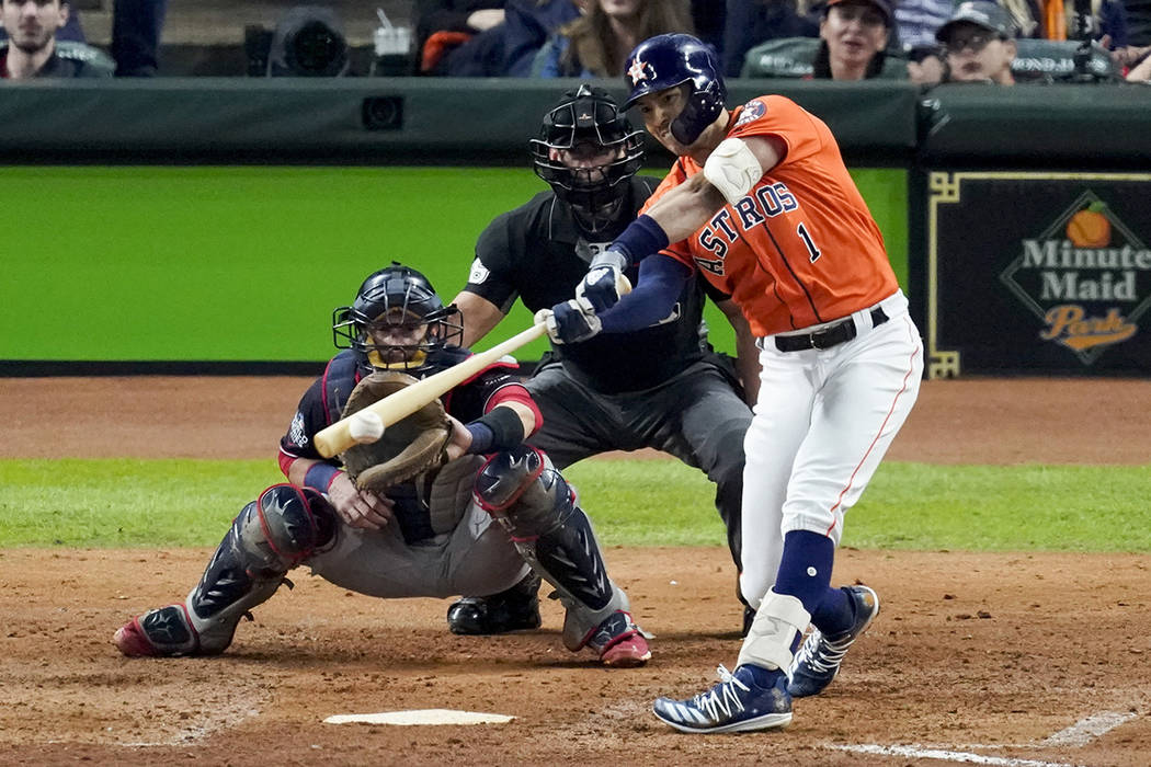 Houston Astros' Carlos Correa hits a RBI-single against the Washington Nationals during the fif ...