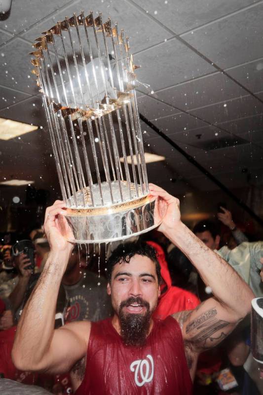 Washington Nationals third baseman Anthony Rendon celebrates with the trophy in the locker room ...