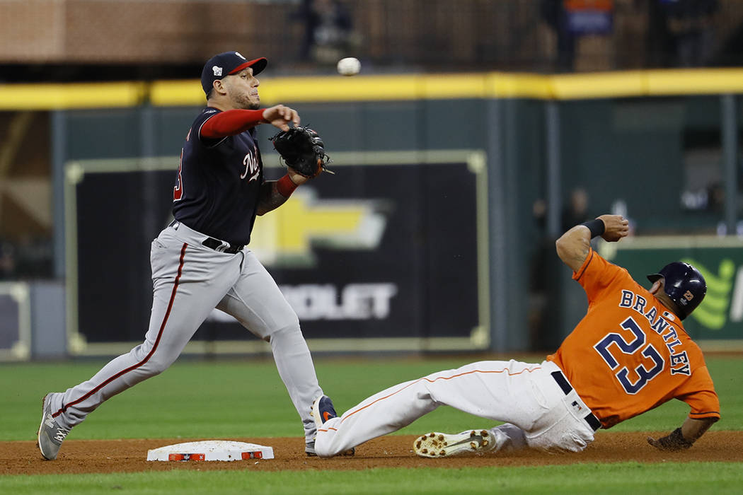 Houston Astros' Michael Brantley is out as Washington Nationals' Asdrubal Cabrera tries to doub ...