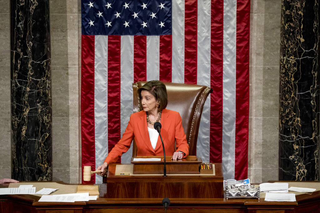 House Speaker Nancy Pelosi of Calif. gavels as the House votes 232-196 to pass resolution on im ...