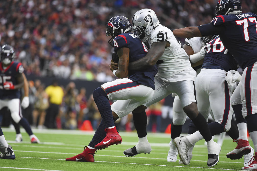 Houston Texans quarterback Deshaun Watson (4) is hit by Oakland Raiders defensive end Benson Ma ...