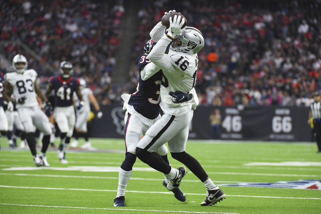 Oakland Raiders wide receiver Tyrell Williams (16) is hit by Houston Texans defensive back Keio ...