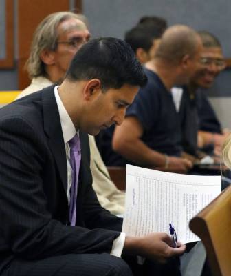 Chief Deputy District Attorney Jay P. Raman reviews documents before a hearing at the Regional ...