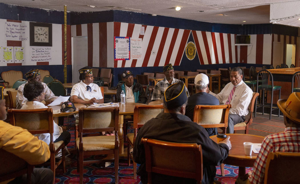 Veterans Program Director at American Legion Post 10 Commander Grady Hayes, background right, s ...