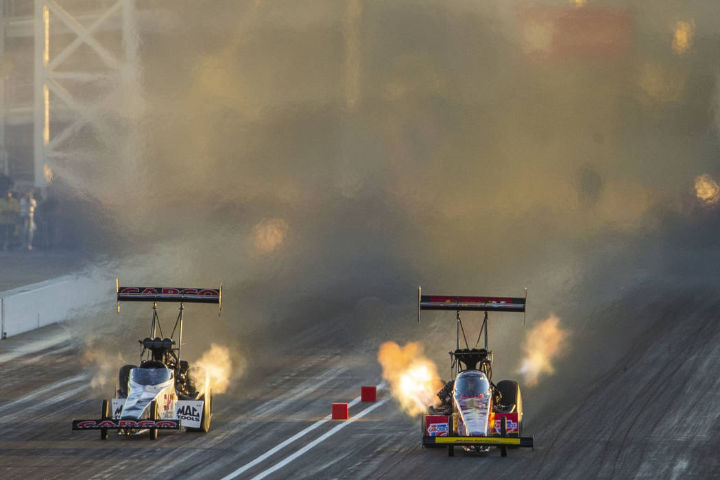 Top Fuel racers Steve Torrence and Brittany Force stay close during the final round of the Dodg ...