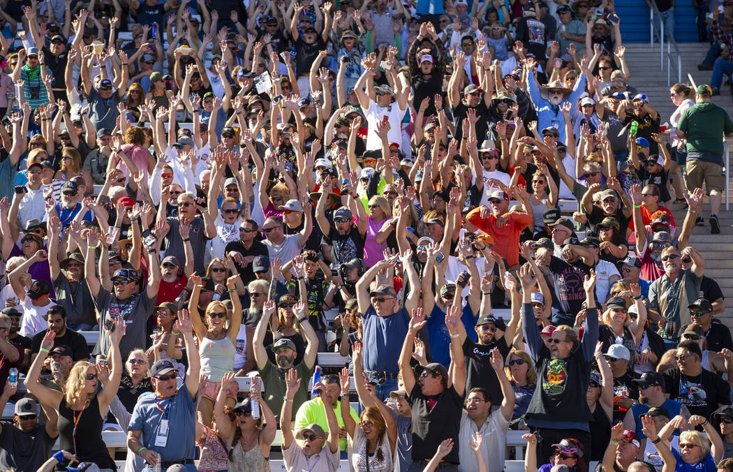 Fans stand and do the "wave" during the second round of the Dodge NHRA Nationals at t ...