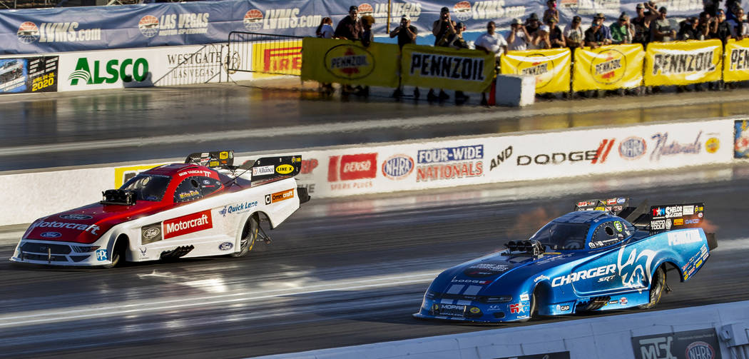 Funny car racers Bob Tasca III, left, and Matt Hagan battle for the lead in the second round du ...