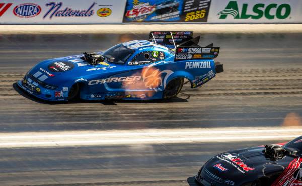 Funny car racer Matt Hagan, above, takes the lead in the first round during the Dodge NHRA Nati ...