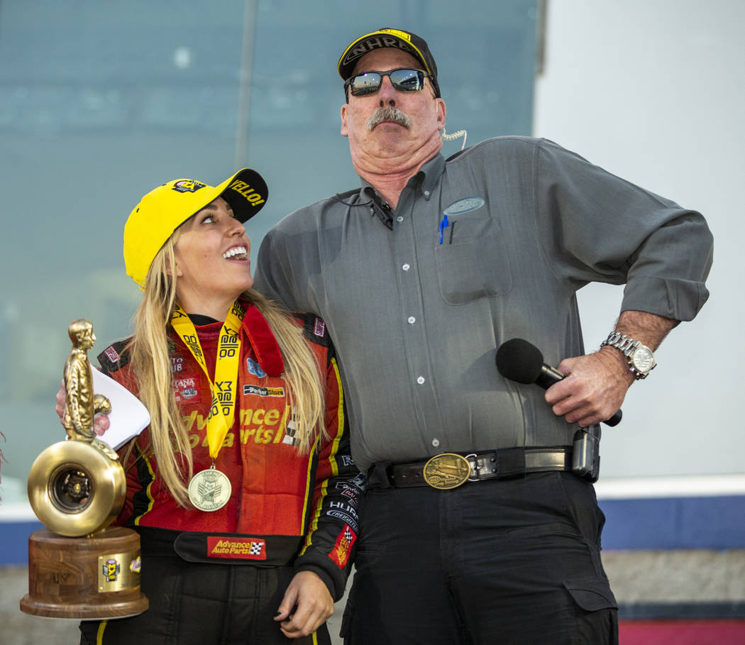 Top Fuel race winner Brittany Force, left, looks to NHRA announcer Alan Reinhart who acts the p ...