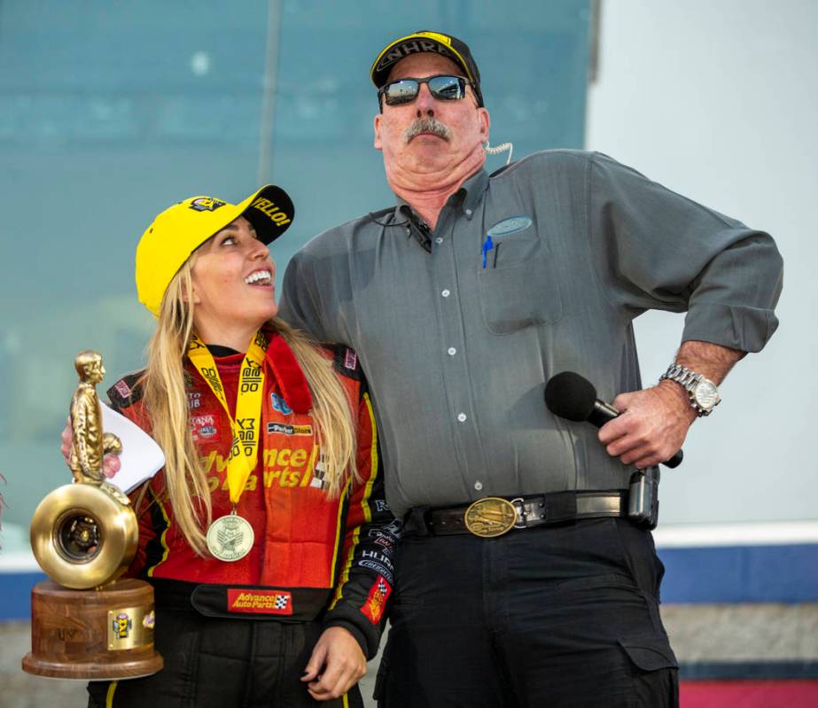 Top Fuel race winner Brittany Force, left, looks to NHRA announcer Alan Reinhart who acts the p ...