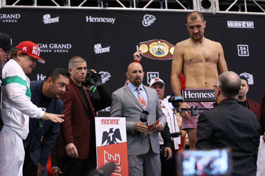 People watch as Sergey Kovalev steps on the scale during a weigh-in event at the MGM Grand Gard ...