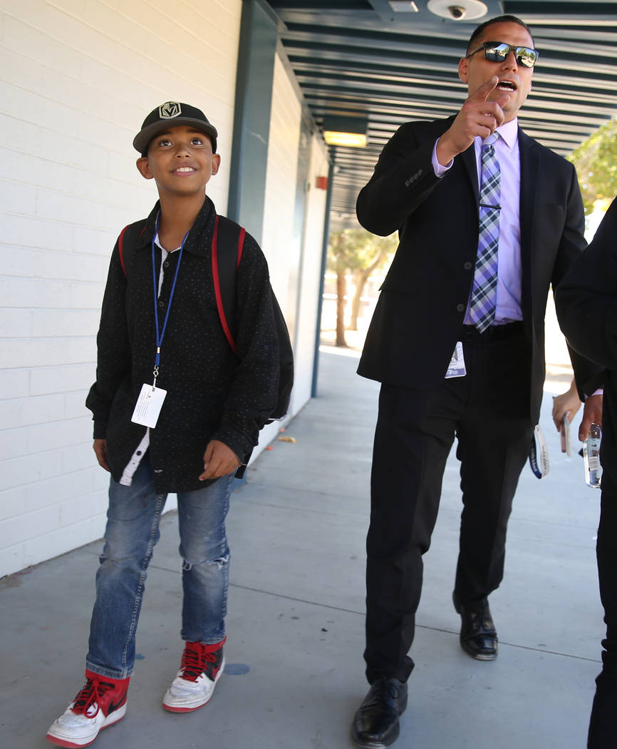 Principal Anthony Nunez walks sixth grader Albert Breedlove back to class to get a pass at Orr ...