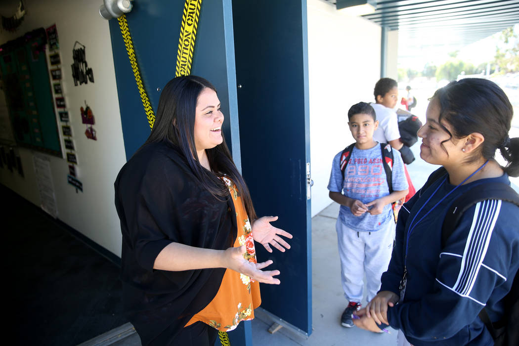 Teacher Myra Gomez congratulates seventh grader Diana Tobon on making the cheerleading squad du ...