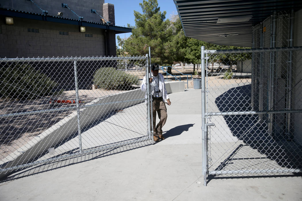 Monitor Henry Grant closes the fence after lunch at Orr Middle School in Las Vegas Monday, Oct. ...