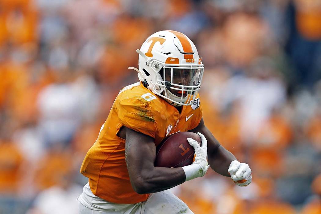 Tennessee running back Ty Chandler (8) runs for yardage in the first half of an NCAA college fo ...