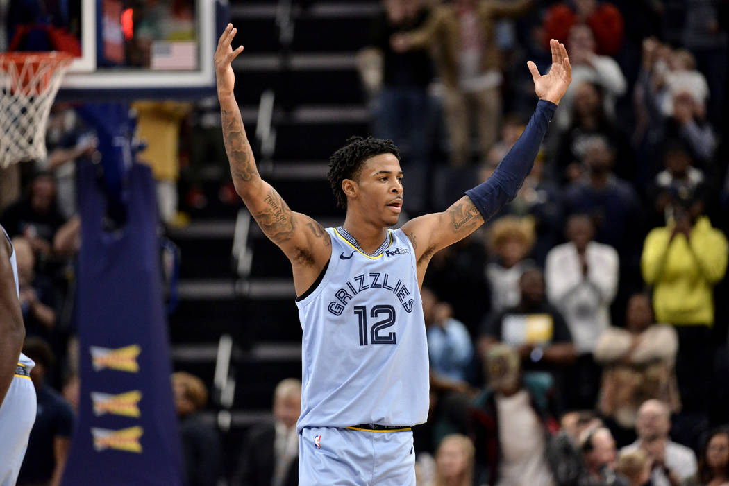 Memphis Grizzlies guard Ja Morant (12) gestures to the crowd in the second half of an NBA baske ...