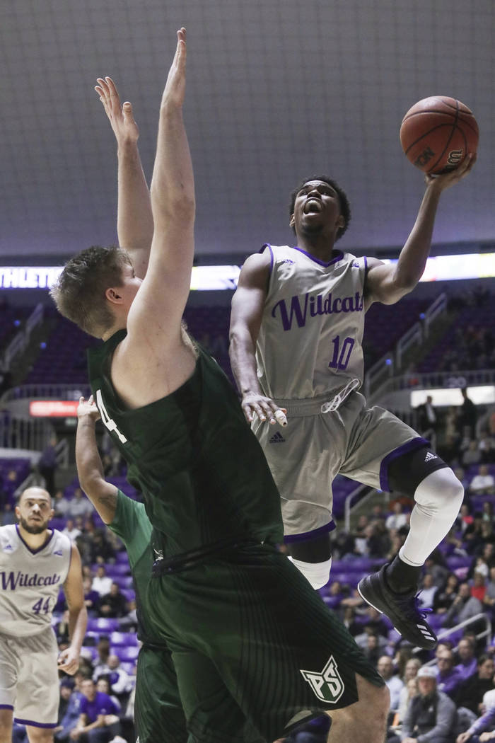 Weber State's Jerrick Harding (10) goes to the basket as Portland State's Ryan Edwards (44) def ...