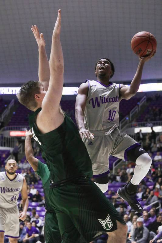 Weber State's Jerrick Harding (10) goes to the basket as Portland State's Ryan Edwards (44) def ...