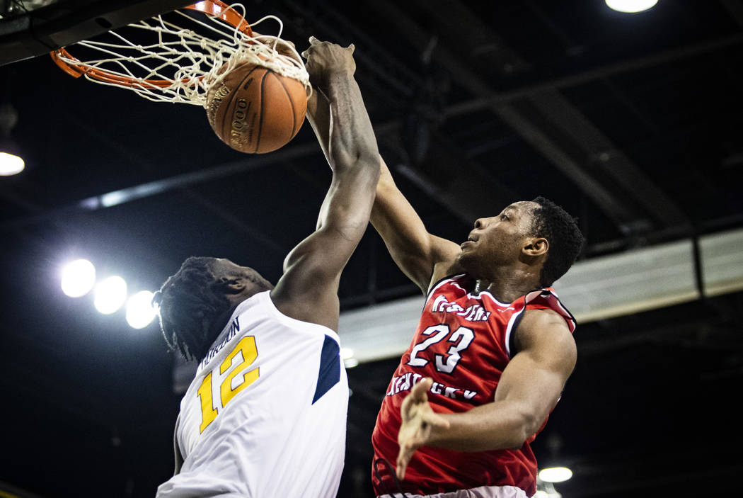 Western Kentucky center Charles Bassey (23) dunks over West Virginia Mountaineers forward Andre ...