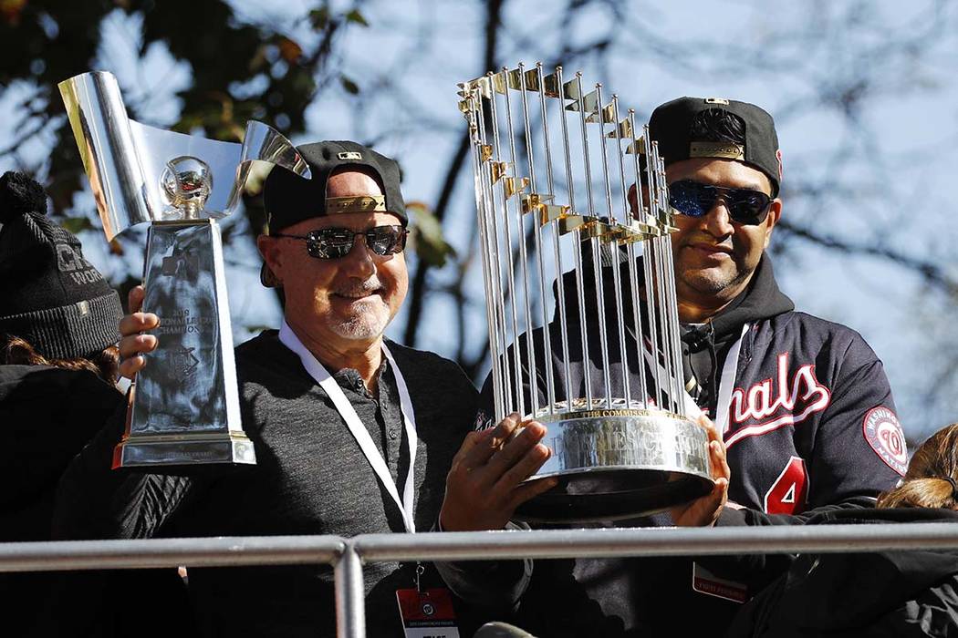 Washington Nationals general manager Mike Rizzo, left, and manager Dave Martinez hold up the NL ...